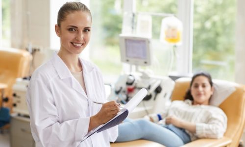 portrait-female-doctor-smiling-camera-while-examining-patient-hospital_249974-4252